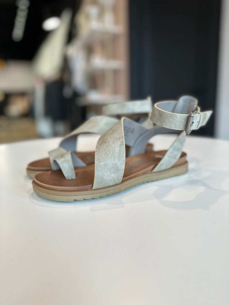 Strappy cream gray leather sandal with cushioned foot bed. Toe strap and ankle buckle