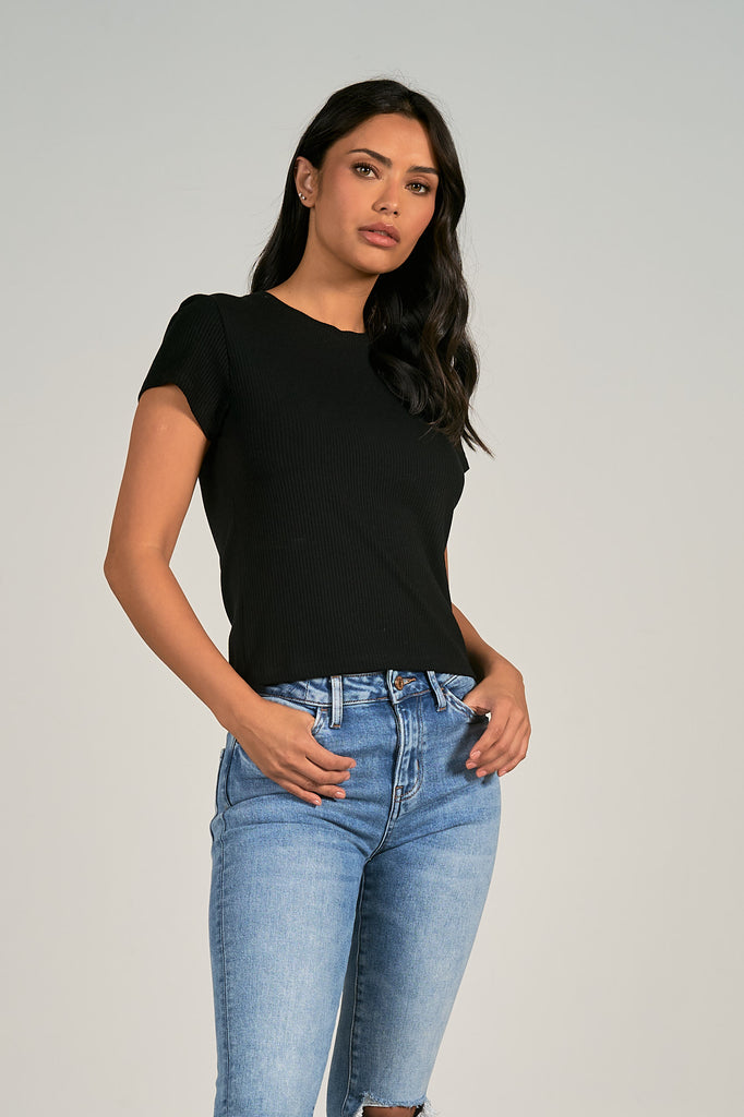 Woman wearing a black ribbed crewneck tee shirt, basic tee, capsule wardrobe piece
